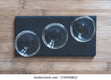 Angri, Italy. Empty Glass Bowls On A Slate Plates Taken From Above. Overhead Shot. Props For Food Photography.