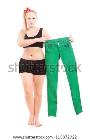Angry 40 size girl holding 36 size trousers