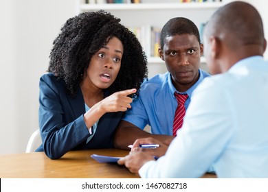 Angry african american couple rejecting contract offer of real estate agent - Shutterstock ID 1467082718