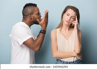 Angry African American man in glasses blaming upset stressed woman, emotional boyfriend and girlfriend fighting, diverse couple in quarrel, break up, family problem, isolated on studio background