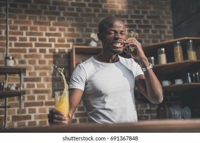 Angry African American Man Shed Juice During Tense Phone Conversation