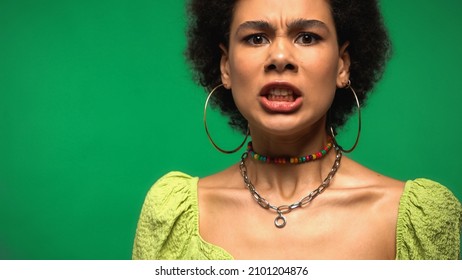 Angry African American Woman In Hoop Earrings Isolated On Green