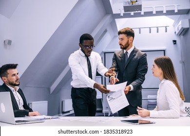 Angry African Businessman Points Finger At Document Boss Scolds Employee For Poor Performance, Workplace Conflict, Unpleasant Behavior In Office