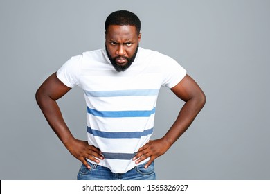Angry African-American man on grey background