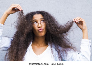 Angry afro girl pulling her hair