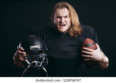 Angry American Football Coach Holding Football Ball Over Isolated Background, Ready To Fight For Win, Shouting With Anger And Excitement, Sport And Emotions Concept