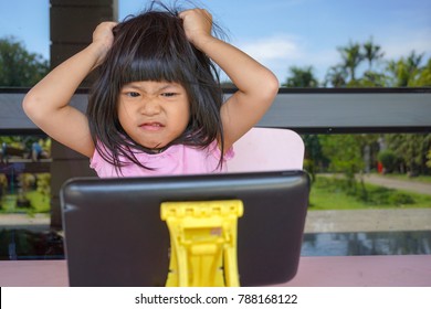 Angry Asian Cute Girl Screaming Because Her Mother Try To Take Her Tablet Away. Stressed Child,
Kid  With Attention Deficit Hyperactivity Disorder (ADHD) Can't Handle Her Emotion.

