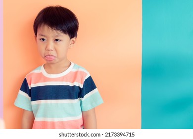 Angry Asian Kid.Asian Boy Child Looking At His Mother And Fighting With Her Mom.Furious Toddler Kid Got Upset And Sad.Stubborn Child Bad Attitude.Depressed Little Boy Complaining With Mom.stubborn