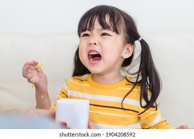 Angry Asian Kid.Little Asian Girl Looking At Her Mother And Fighting With Her Mom.Furious Hungry Toddler Kid Got Upset And Sad.Stubborn Child Bad Attitude.Depressed Little Girl Complaining With Mom.