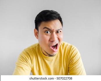 Angry Asian Man In Yellow Shirt.