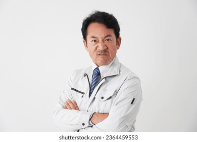 Angry Asian middle aged worker in white background - Shutterstock ID 2364459553