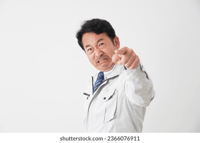 Angry Asian middle aged worker in white background - Shutterstock ID 2366076911