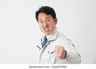 Angry Asian middle aged worker in white background - Shutterstock ID 2366077051
