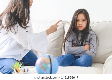 Angry Asian Mother Sitting With Little Daughter , Mom Scolds For Discipline Bad Behaviour Capricious Kid, Family Generations Problems, Misunderstanding Concept