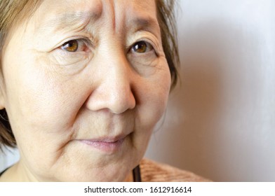 Angry Asian Senior Woman. Look Angrily At Camera With Grimacing Mad Face, Dissatisfied Mature Lady Show Irritation And Discontent, Having Bad Mood Negative Emotions