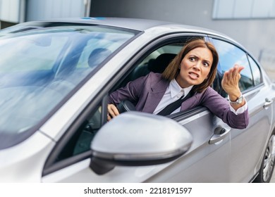 Angry Attractive Caucasian Woman Yelling At Other Drivers While Sitting In Car.