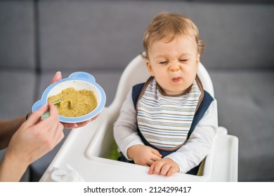 Angry baby boy doesn't want to eat. - Shutterstock ID 2124299417