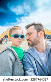 Angry Bearded Dad Looking At His Son In Sunglasses