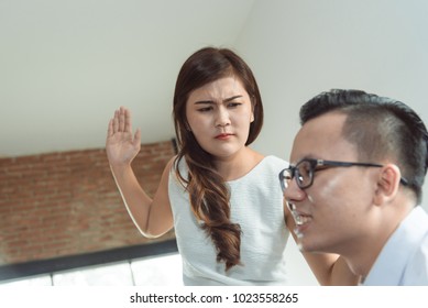 Angry beautiful Asian woman a slap in the face with Her husband was his wife because of divorce cheating concept in the bedroom.