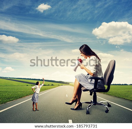 angry big woman with megaphone and small woman on the road