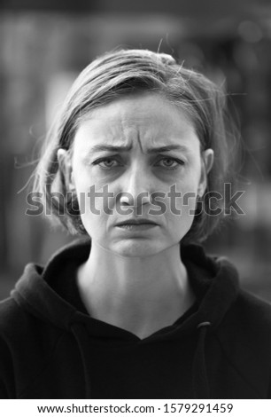 Angry blonde woman looking to the camera. Black and White photo.