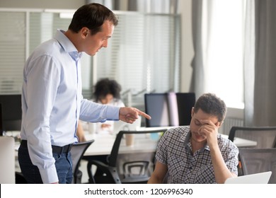 Angry boss ceo scolding rebuking incompetent office worker intern, dissatisfied team leader shouting pointing finger at lazy employee for bad work failure, reprimand or discrimination at work concept