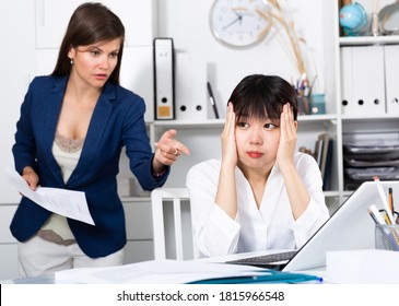 Angry Boss Criticizing Sad Frustrated Female Asian Employee At Work