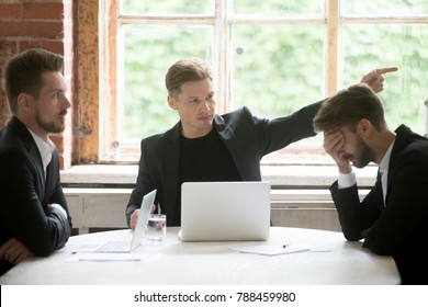 Angry boss firing unprofessional employee with hand gesture at office meeting, dissatisfied ceo dismissing male incompetent manager for poor performance or bad work result sitting at conference table