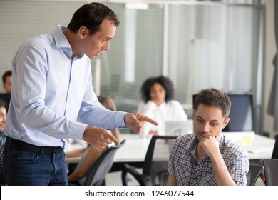 Angry Boss Scolding Frustrated Incompetent Employee At Workplace, Dissatisfied Leader Shouting, Pointing Finger At Bad Office Worker For Bad Work, Laziness, Sad Man Getting Reprimand, Job Loss Concept
