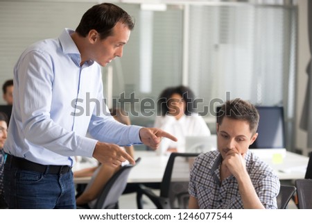 Angry boss scolding frustrated incompetent employee at workplace, dissatisfied leader shouting, pointing finger at bad office worker for bad work, laziness, sad man getting reprimand, job loss concept