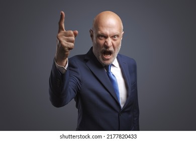 Angry boss shouting at camera, he is scolding an employee