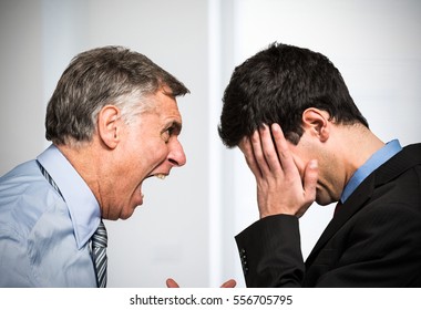 Angry boss shouting to an employee - Shutterstock ID 556705795