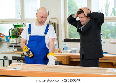 Angry Boss And Worker Together In A Carpenter's Workshop