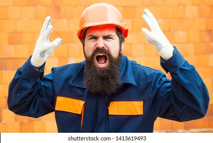 Angry Builder. Incident At A Construction Site. Safety Rules For Builders. Bearded Man In Helmet On The Construction Of A New Building.