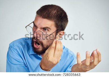 angry business  man screams in glasses on a light background                               