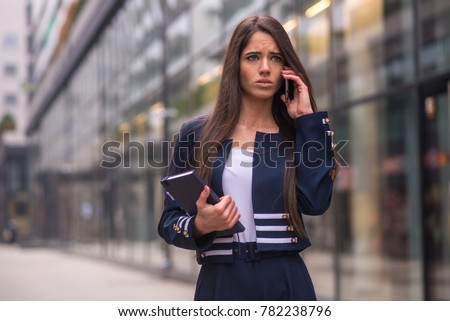Angry business woman talking on phone
