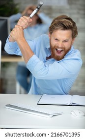 Angry Businessman With Beard Holding Hammer