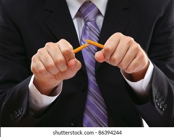 Angry businessman breaking pencil isolated - Powered by Shutterstock