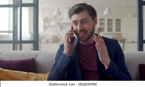 Angry Businessman Gesturing With Phone At Home Office In Slow Motion. Portrait Of Furious Guy Throwing Away Phone On Sofa. Closeup Upset Man Relaxing After Nervous Conversation.