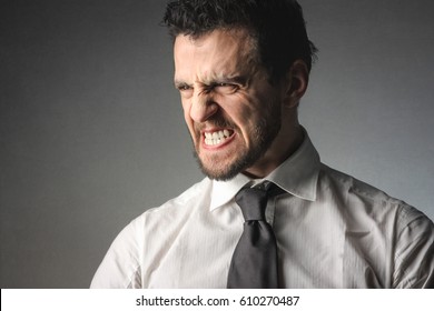 Angry businessman grinding his teeth