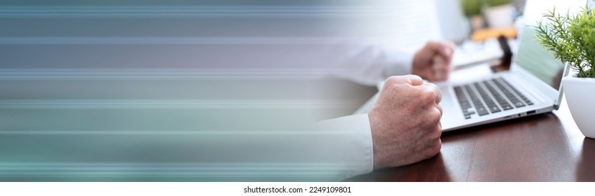 Angry businessman hitting his desk with his clenched fists; panoramic banner - Shutterstock ID 2249109801