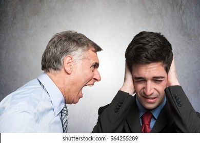 Angry businessman shouting to an employee - Shutterstock ID 564255289