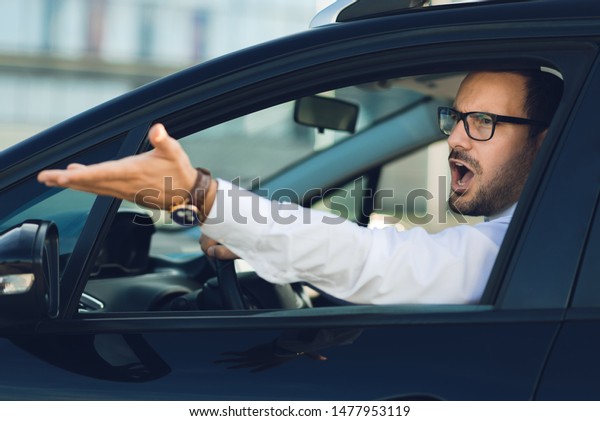 Angry businessman\
yelling out car window