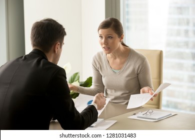 Angry businesswoman arguing with businessman about paperwork failure at workplace, executives having conflict over responsibility for bad work results, partners disputing about contract during meeting