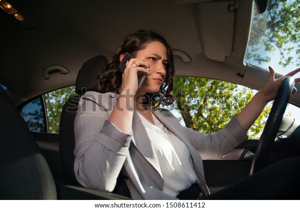 Angry businesswoman driving a\
car