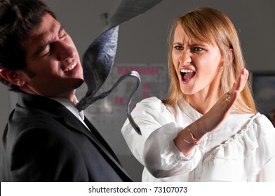 Angry Businesswoman Is Slapping Across The Businessman's Face