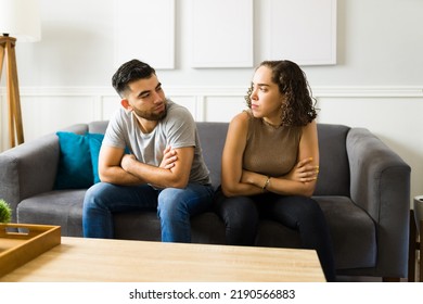 Angry caucasian couple looking at each other and feeling annoyed after a fight because of communication problems - Shutterstock ID 2190566883