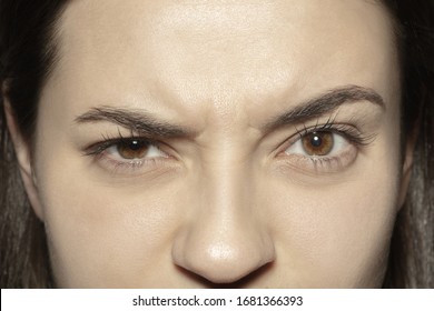 Angry. Close Up Of Face Of Beautiful Caucasian Young Woman, Focus On Eyes. Human Emotions, Facial Expression, Cosmetology, Body And Skin Care Concept. Well Kept Cheeks, Narutal Make Up. Wellbeing.