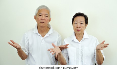 Angry Complaining Asian Elderly Couple With Upset Expression And Gesture