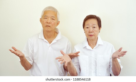 Angry Complaining Asian Elderly Couple With Upset Expression And Gesture